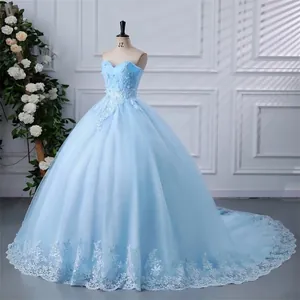 Detailed view of exquisite white lace embroidery on a light blue ballgown dress