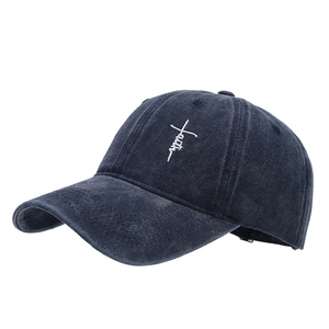Unisex washed canvas baseball cap featuring white cross and faith embroidery detail