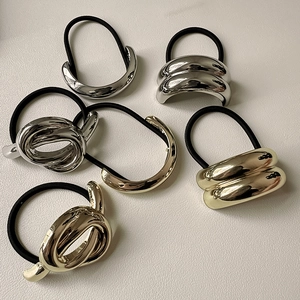 Detail of 6-piece elastic hair tie set with polished gold and silver geometric metal accents