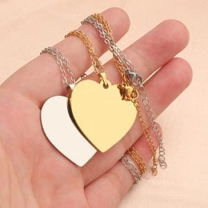 Polished heart-shaped pendant necklace in gold and silver finish on hand display