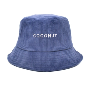 Detailed view of blue corduroy bucket hat with white COCONUT embroidery text
