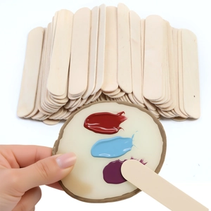Macro shot of natural birch wood wax sticks with colorful pigment application detail