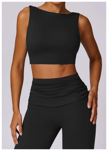 Detail of high-waist ruched yoga pants and sleeveless crop top in black matte fabric
