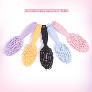 Detail of five colorful vented hairbrushes with spiral design and hanging holes