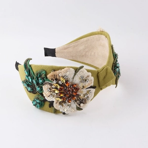Detail of bohemian floral headband with embroidered petals and sparkling rhinestones
