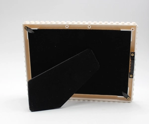 Detailed back view of block photo frame with adjustable stand and metal wall hook