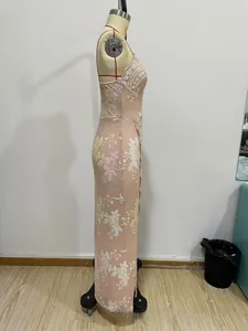 Detail of sequins floral embroidery on backless evening dress with side slit