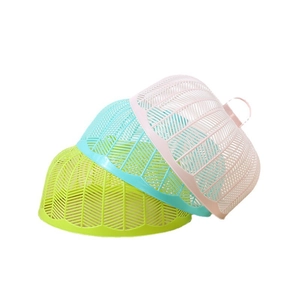 Three colorful round plastic mesh food covers for dining tables in green, blue, and pink