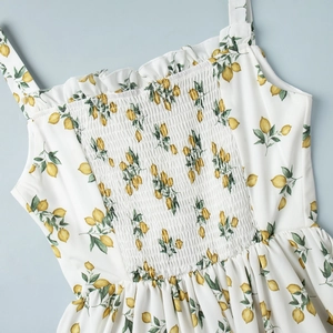 Close-up of smocked bodice and ruffle neckline on lemon print floral sundress