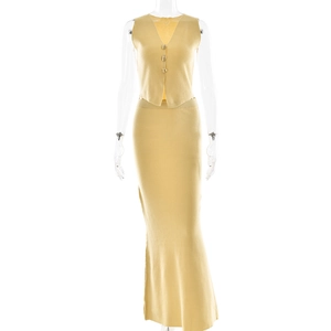 Detail of yellow knit two-piece set featuring a sleeveless vest and long skirt on a model