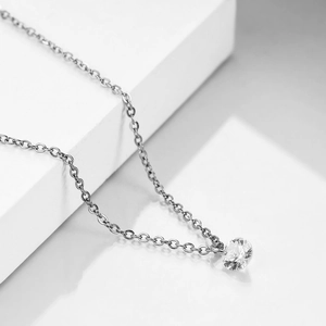 Macro shot of a 6mm round cubic zirconia pendant on a silver-toned cable chain necklace