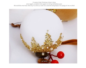 Macro detail of white matte Christmas ball with gold sequins, pearls and brown velvet ribbon