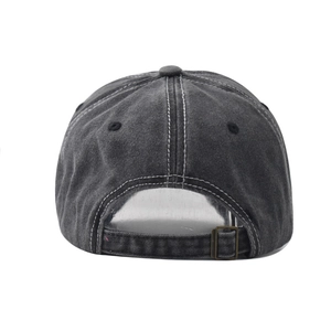 Detail of washed cotton baseball cap with adjustable metal buckle and distressed texture