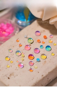 Macro view of iridescent mermaid symphony glass beads for artistic nail decoration