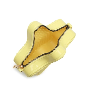 Chic yellow PVC jelly handbag with top zipper and gold hardware from a top-down view
