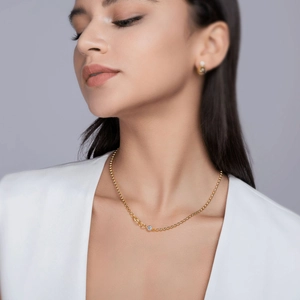 Golden 925 sterling silver layered necklace with moissanite pendant worn by a model