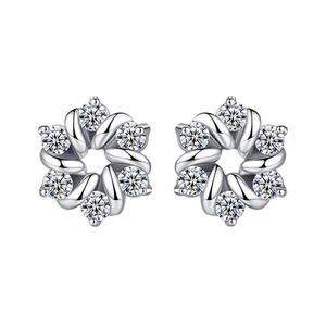 Close-up of silver-toned flower stud earrings featuring six petals with sparkling zircons