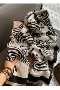 Detailed texture of zebra print scarf with tassels, thick warm fabric for winter fashion