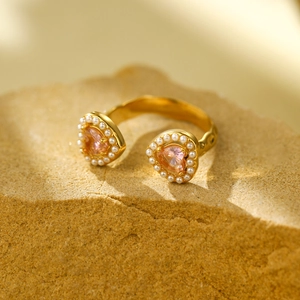 Double heart ring in gold titanium steel with pink gemstone and pearl details on stone