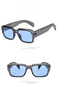 Detail of transparent grey square frames and blue lenses on these retro sunglasses