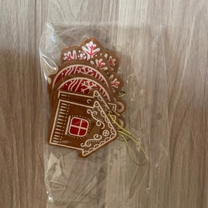 Close-up of assorted non-woven gingerbread and snowflake Christmas tree hanging ornaments