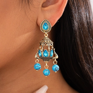 Close-up of bohemian chandelier earrings with sky blue stones and turquoise beads