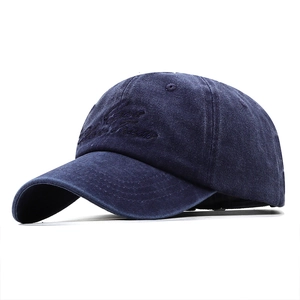 Detailed close-up of vintage navy blue washed cotton baseball cap with 3D embroidery