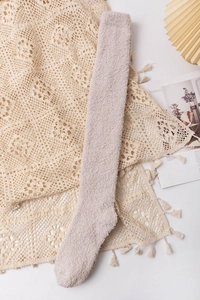 Detailed texture of thick coral fleece winter socks in light beige for women