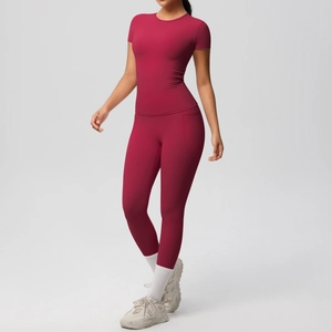 Detail of red high-stretch yoga set featuring slim-fit short sleeve T-shirt and leggings