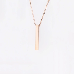 Macro detail of rose gold stainless steel rectangle pillar pendant on a fine link chain