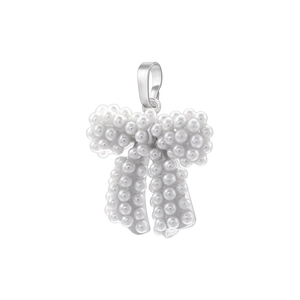 Close-up of pearl-encrusted bow pendant featuring silver metal base and lustrous white pearls
