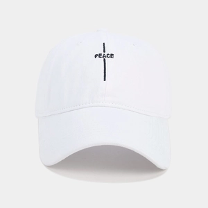 Close-up of black PEACE letter embroidery on a white minimalist baseball cap