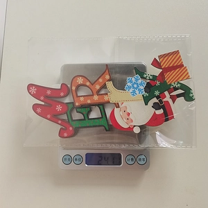 Close-up of a festive wooden Merry Christmas sign featuring Santa Claus and colorful letters