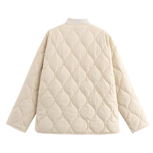 Detail of leaf-patterned quilting on cream white oversized jacket with ribbed collar