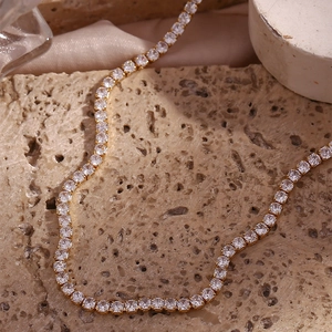 Classic 14K gold plated tennis necklace with sparkling round zircon on stone background