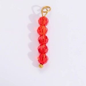 Close-up of a handmade red faceted crystal bead pendant with an 18k gold-plated loop