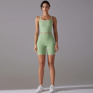 Front view of seamless light green yoga set featuring a scoop neck top and high-waist shorts