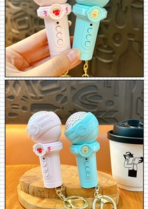 Close-up of cute microphone keychains in pink and blue with sweet character details