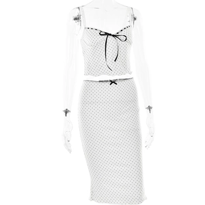 Detail of white polka dot crop top and skirt set with black bows and lace trim