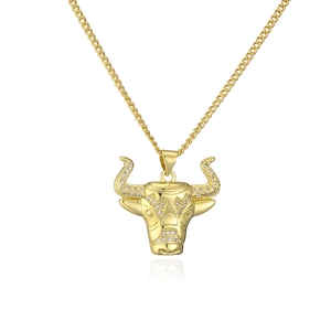 Macro view of 18K gold plated bull head pendant featuring sparkling zircon accents