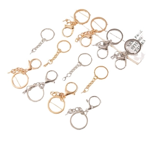 DIY metal keychain set with silver and gold lobster clasps and chain rings on white background