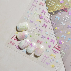Cute macaron color 3D nail stickers featuring stars and bows on white manicured nails