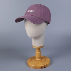 Detail of purple cotton baseball cap with white Surfing letter embroidery and curved brim