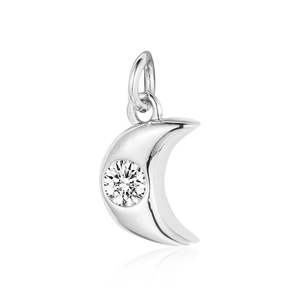 Macro view of a silver crescent moon pendant with a single round sparkling zircon stone