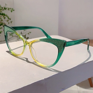 Detail of cat eye glasses frame with green-yellow gradient and golden glitter top finish
