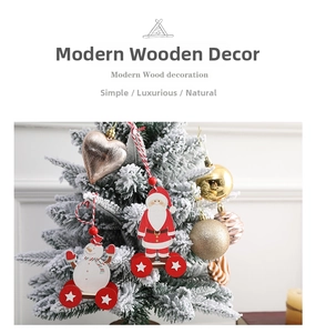 Detail of wooden Santa and Snowman cart ornaments hanging on a snowy Christmas tree