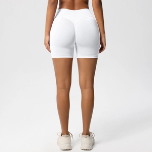 Detail view of white seamless yoga shorts with high waist and v-cut peach lift design