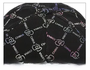 Detailed top view of a black baseball cap featuring laser-printed letters and six-panel seams