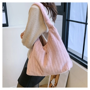 Close-up of pink plush tote bag showing soft vertical stripe texture and large capacity