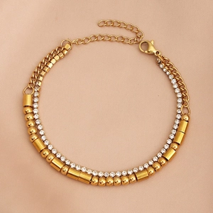 Detail view of triple-layered gold Morse code bracelet with rhinestones and bead chains